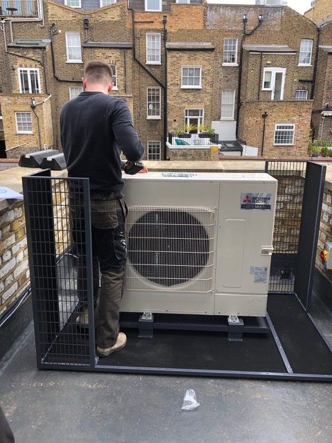 Engineer servicing an outdoor air conditioning unit